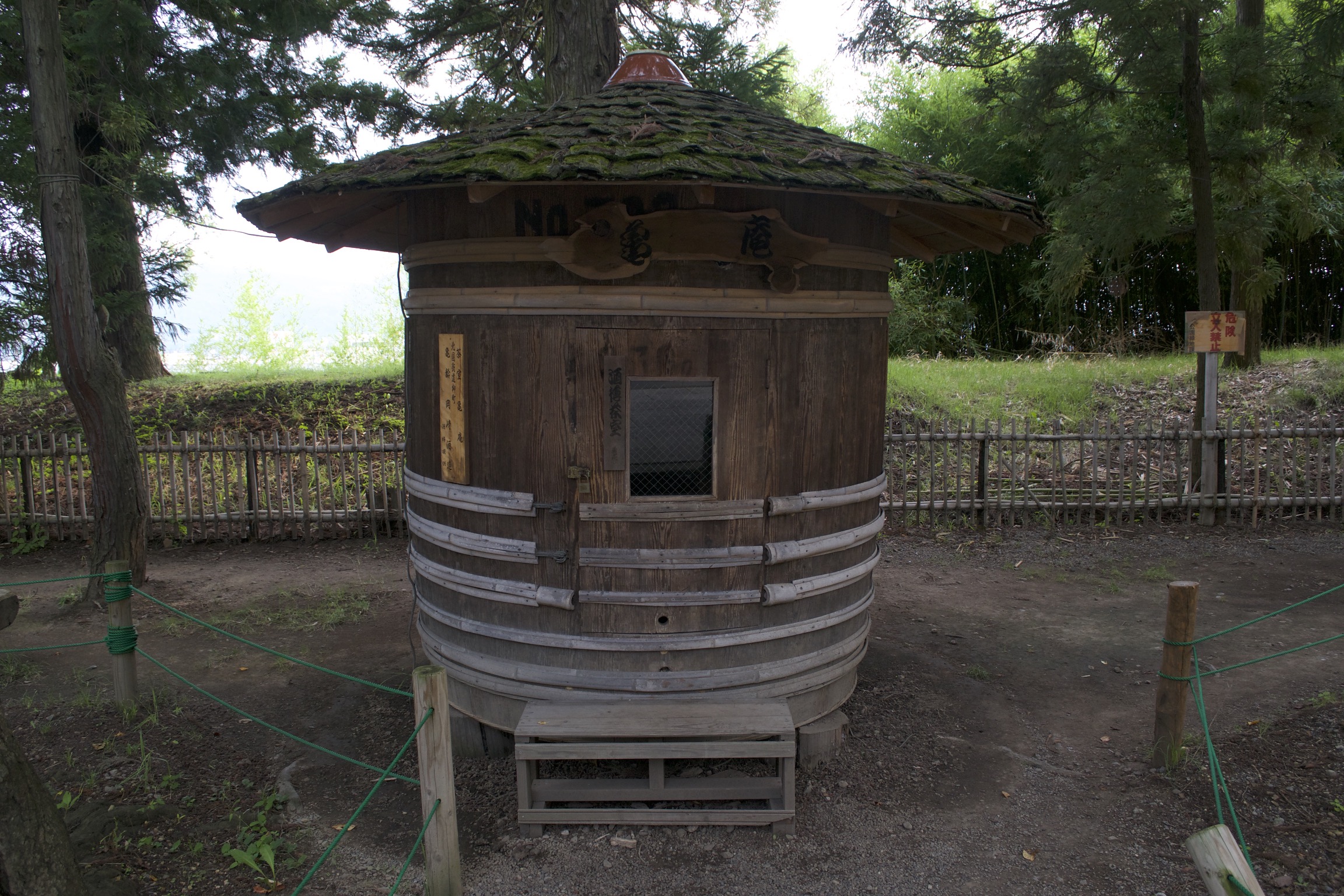 A big wooden barrel with a mossy roof.